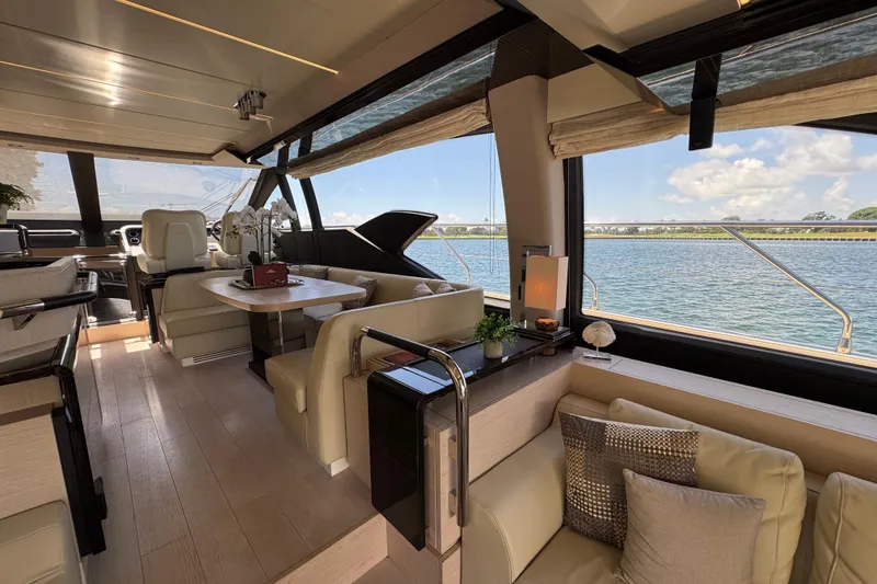 Slide: The Image of Luxurious interior of 2018 Azimut 66 Flybridge yacht with elegant seating and scenic water views. - 26