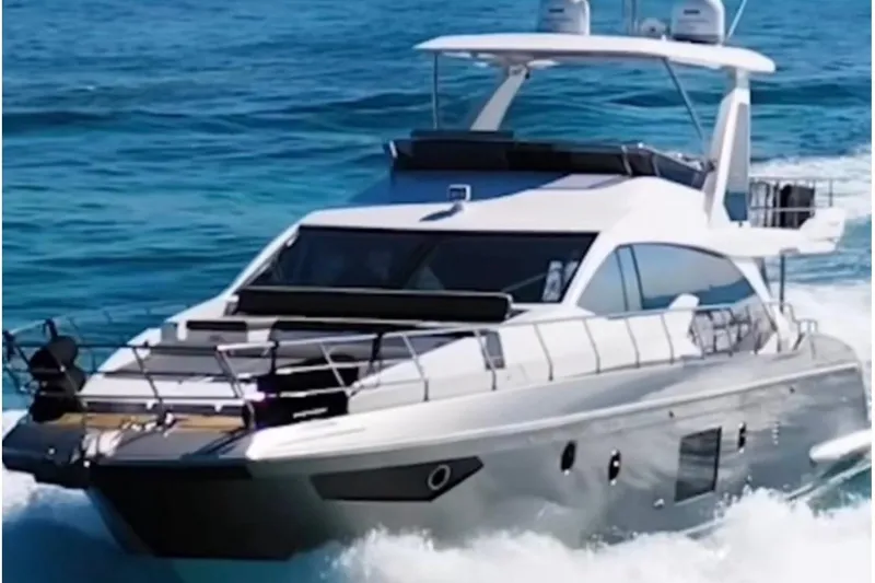 Slide: The Image of 2018 Azimut 66 Flybridge yacht cruising on open water. - 1