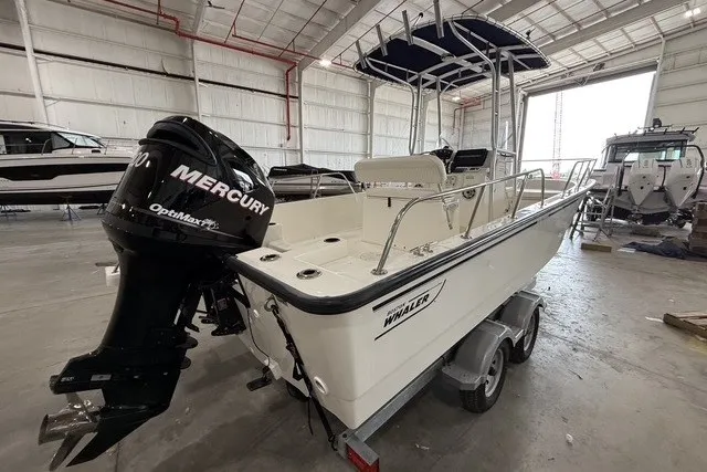 Slide: The Image of 2015 Boston Whaler 210 Montauk boat with Mercury engine in a warehouse setting. - 4