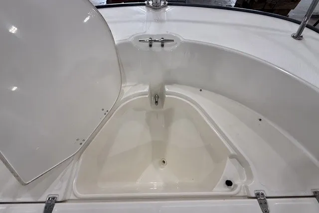 Slide: The Image of 2015 Boston Whaler 210 Montauk boat storage compartment with open lid. - 14