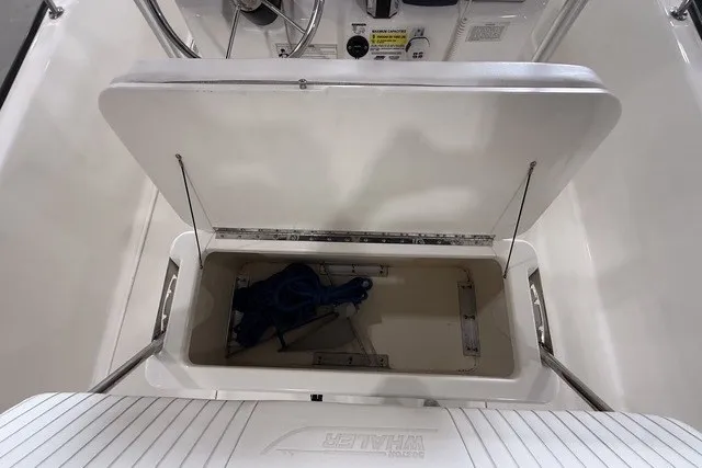 Slide: The Image of Open storage compartment on a 2015 Boston Whaler 210 Montauk boat, showing interior space. - 15
