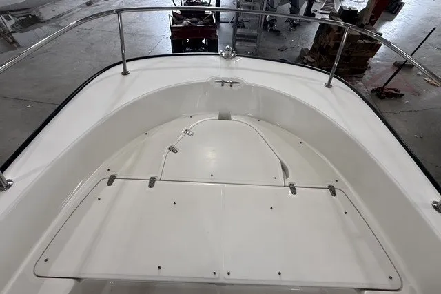 Slide: The Image of 2015 Boston Whaler 210 Montauk boat interior, featuring spacious deck and stainless steel railings. - 12