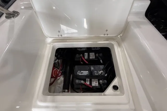 Slide: The Image of 2015 Boston Whaler 210 Montauk battery compartment with dual batteries and wiring. - 17