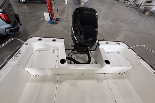 Slide: The Image of 2015 Boston Whaler 210 Montauk boat interior with Mercury outboard motor in a garage. - 16