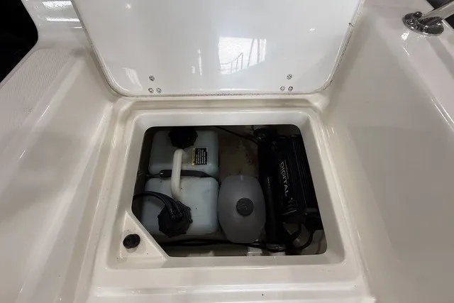 Slide: The Image of Storage compartment of a 2015 Boston Whaler 210 Montauk boat, showing equipment and wiring. - 19