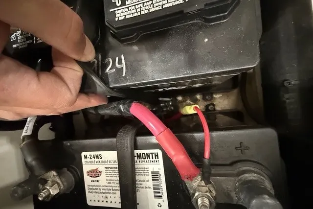 Slide: The Image of Battery compartment of a 2015 Boston Whaler 210 Montauk with visible cables and connections. - 18