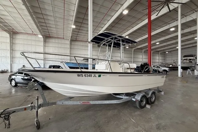Slide: The Image of 2015 Boston Whaler 210 Montauk boat on trailer in indoor storage facility. - 2