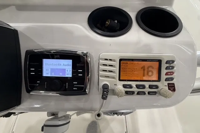 Slide: The Image of Control panel of a 2015 Boston Whaler 210 Montauk with audio and communication systems. - 10