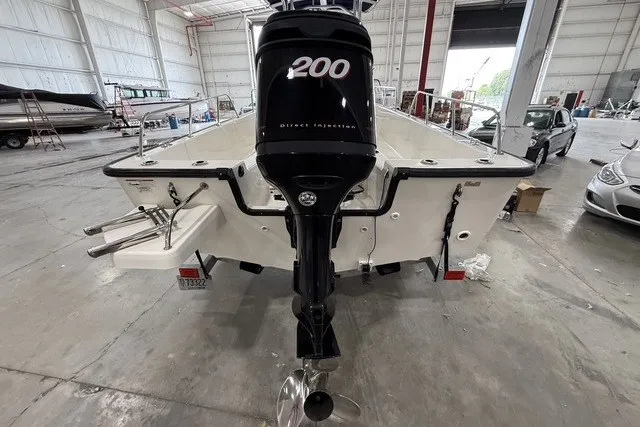 Slide: The Image of 2015 Boston Whaler 210 Montauk boat with 200 HP engine in a warehouse setting. - 5