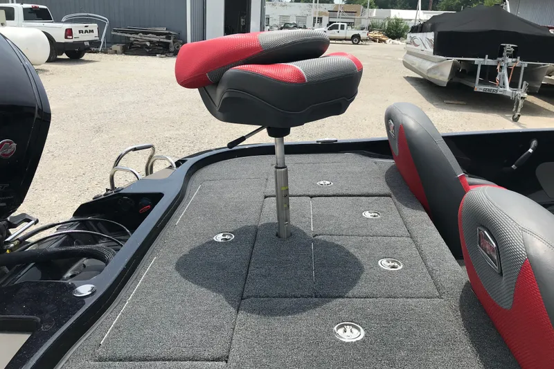Slide: The Image of 2024 Ranger Z185 boat with red and gray seating on a carpeted deck. - 7
