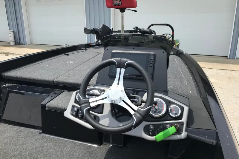 Slide: The Image of 2024 Ranger Z185 boat dashboard with steering wheel and control panel. - 8