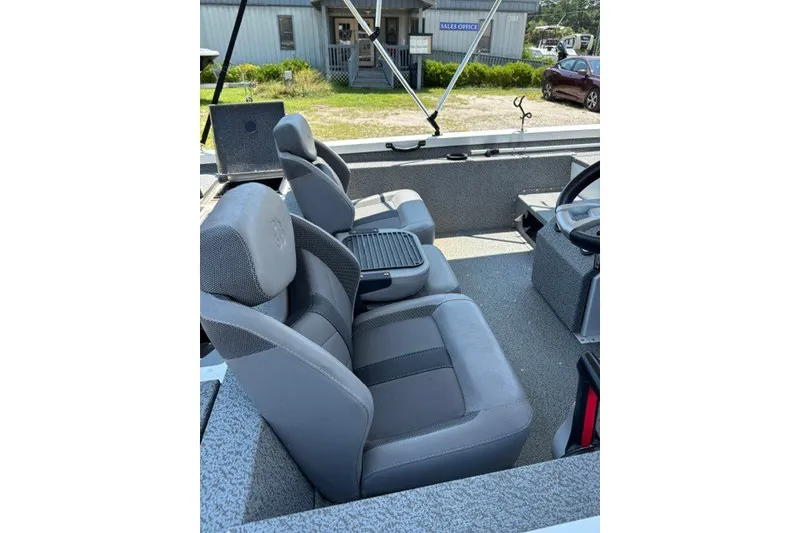 Slide: The Image of 2022 G3 Sportsman 1710 PFX boat interior with gray seating and steering console. - 15