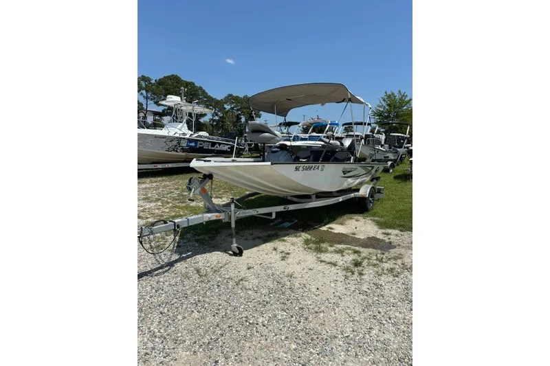 Slide: The Image of 2022 G3 Sportsman 1710 PFX boat on trailer, parked outdoors under clear sky. - 18