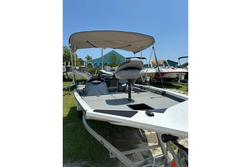 Slide: The Image of 2022 G3 Sportsman 1710 PFX boat with canopy, parked outdoors. - 17