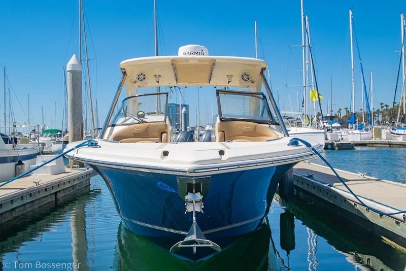 Slide: The Image of 2017 Scout 275 Dorado boat docked in a marina, clear blue sky background. - 2