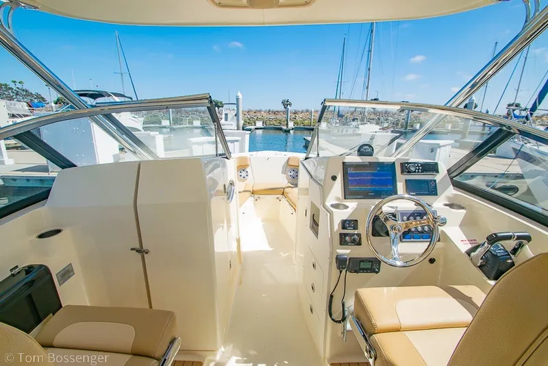 Slide: The Image of Interior view of 2017 Scout 275 Dorado boat, featuring helm and seating area. - 28
