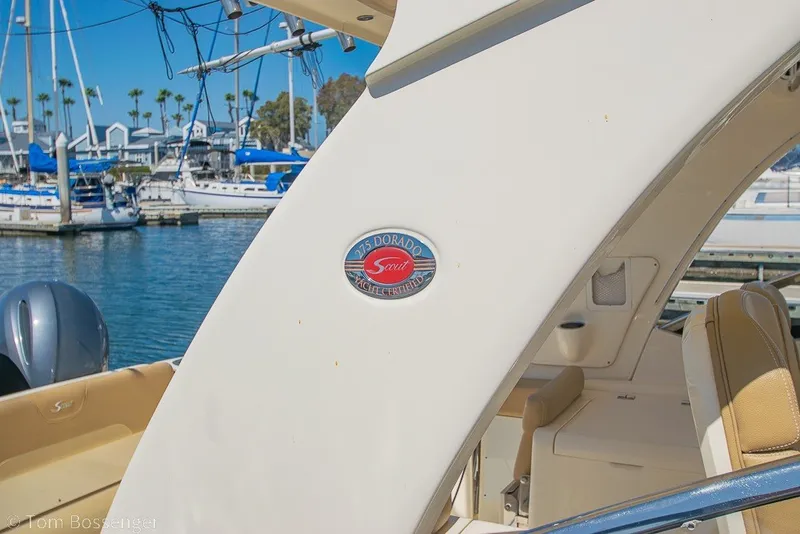 Slide: The Image of 2017 Scout 275 Dorado boat docked at marina with yachts in background. - 3