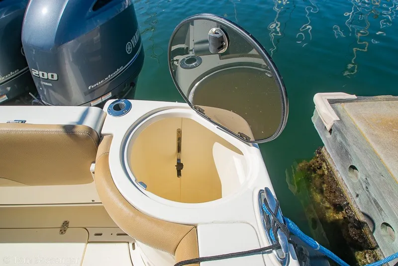Slide: The Image of 2017 Scout 275 Dorado boat with open storage compartment and Yamaha engines at dock. - 44