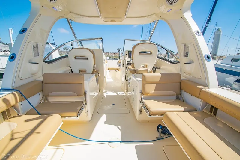 Slide: The Image of Interior of a 2017 Scout 275 Dorado boat with beige seating and open deck. - 15