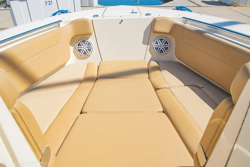 Slide: The Image of 2017 Scout 275 Dorado boat interior with tan seating and built-in speakers. - 22