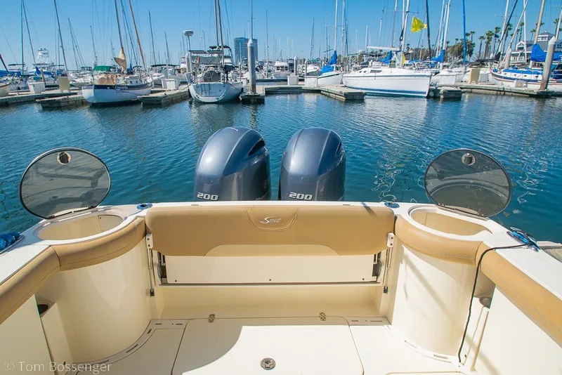 Slide: The Image of 2017 Scout 275 Dorado boat with twin engines docked at a marina. - 43