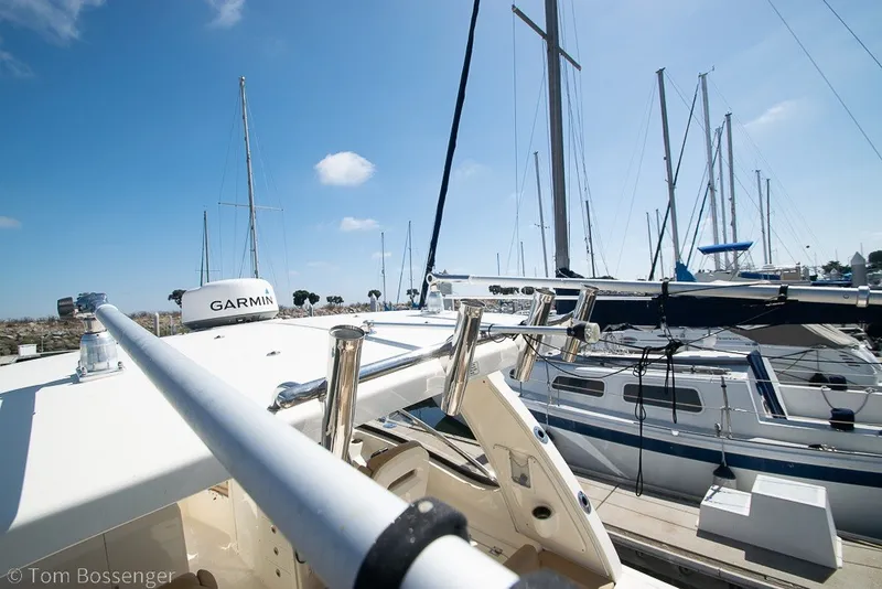Slide: The Image of 2017 Scout 275 Dorado boat docked with clear blue sky and sailboats in background. - 41