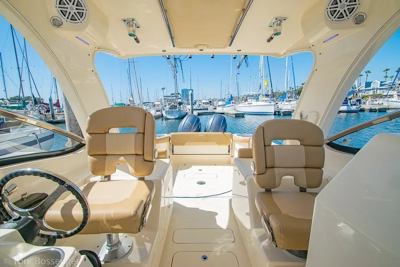 Slide: The Image of Interior view of a 2017 Scout 275 Dorado boat docked at a marina. - 26