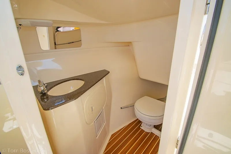 Slide: The Image of 2017 Scout 275 Dorado boat bathroom with sink, toilet, and wooden flooring. - 39