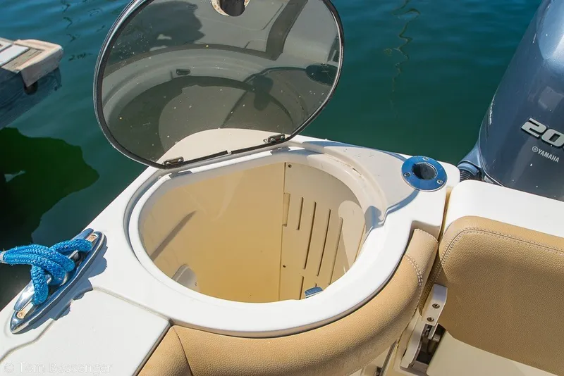 Slide: The Image of Open hatch on 2017 Scout 275 Dorado boat, showing storage compartment and Yamaha engine. - 45