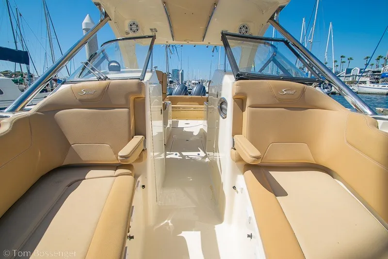 Slide: The Image of 2017 Scout 275 Dorado boat interior with tan seating and clear skies. - 21