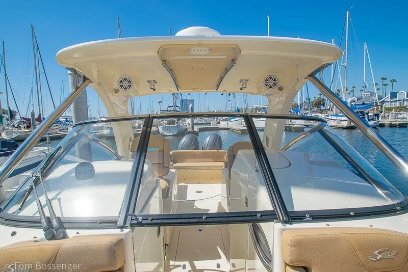 Slide: The Image of 2017 Scout 275 Dorado boat docked at marina under clear blue sky. - 25