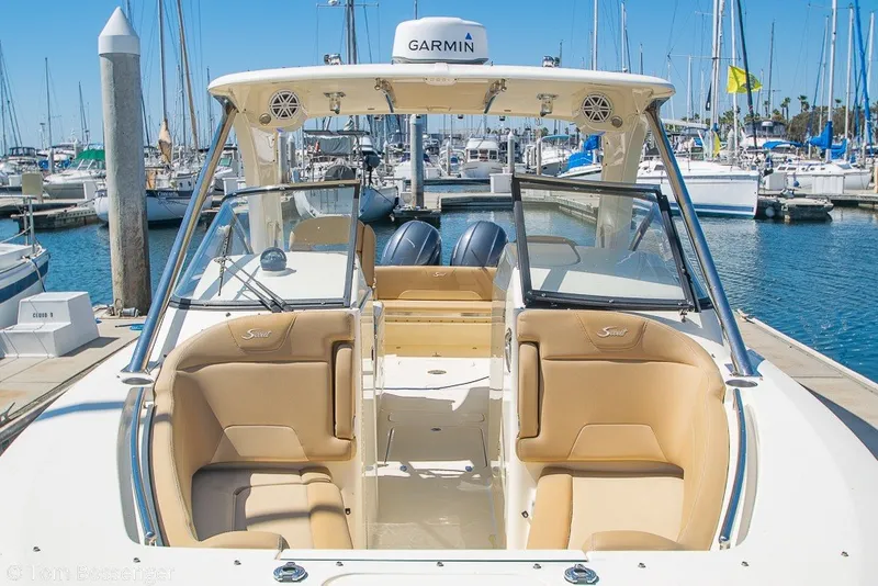 Slide: The Image of 2017 Scout 275 Dorado boat docked at marina with tan seating and Garmin equipment. - 4
