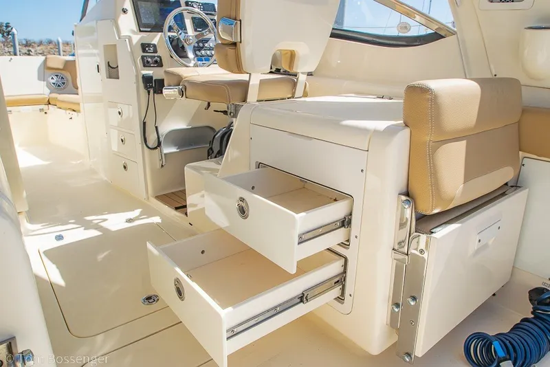 Slide: The Image of Interior of a 2017 Scout 275 Dorado boat with open storage drawers and helm station. - 38