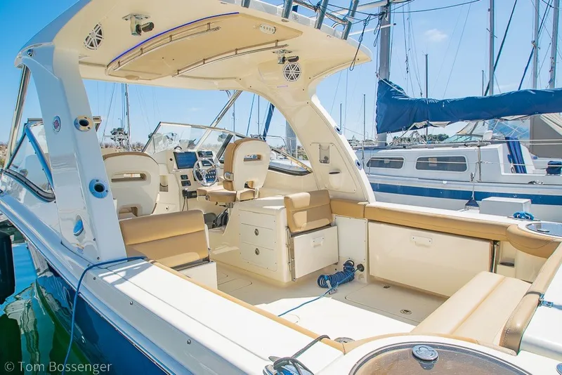 Slide: The Image of 2017 Scout 275 Dorado boat interior with seating and helm, docked at marina. - 8
