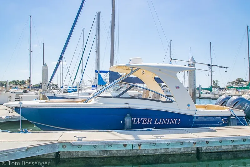 Slide: The Image of 2017 Scout 275 Dorado boat named "Silver Lining" docked at a marina. - 5