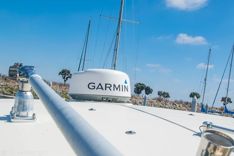 Slide: The Image of 2017 Scout 275 Dorado boat with Garmin radar, clear sky, and marina background. - 42