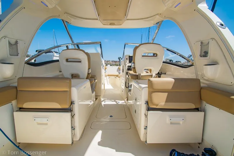 Slide: The Image of Interior of 2017 Scout 275 Dorado boat with beige seating and open cockpit. - 13