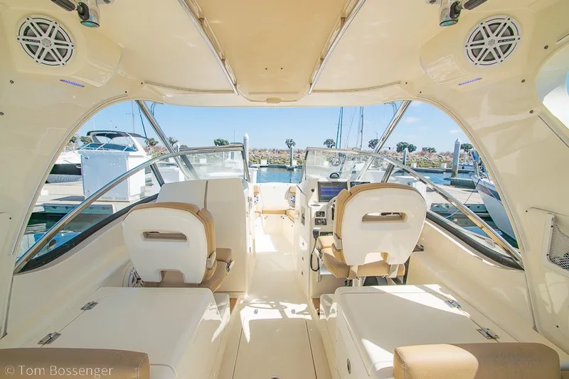 Slide: The Image of Interior view of a 2017 Scout 275 Dorado boat, showcasing seating and helm. - 27