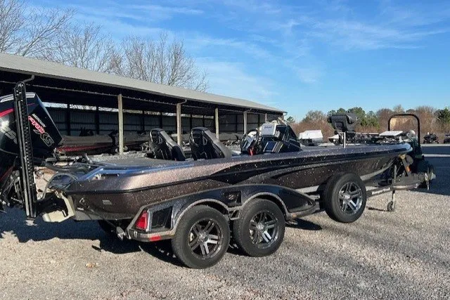 Slide: The Image of 2024 Ranger Z521R boat parked outdoors on gravel, showcasing sleek design and dual-axle trailer. - 6