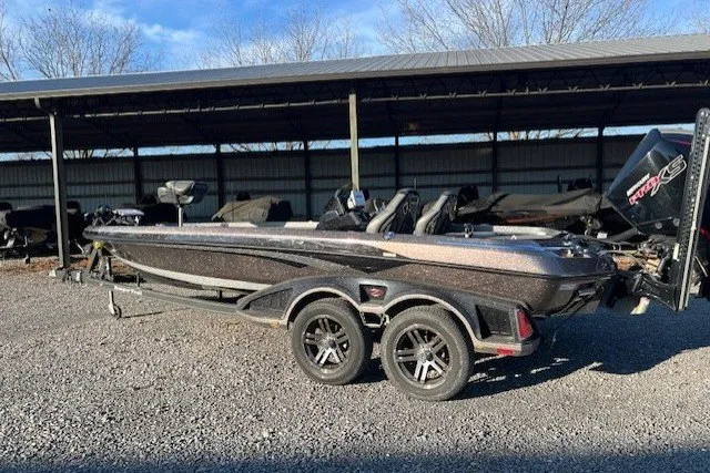 Slide: The Image of 2024 Ranger Z521R bass boat parked on gravel, under a metal canopy. - 8