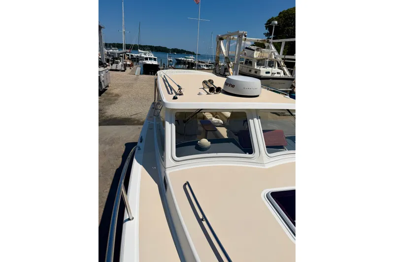 Slide: The Image of 2009 MJM 29z Downeast boat docked at a marina under clear blue skies. - 27