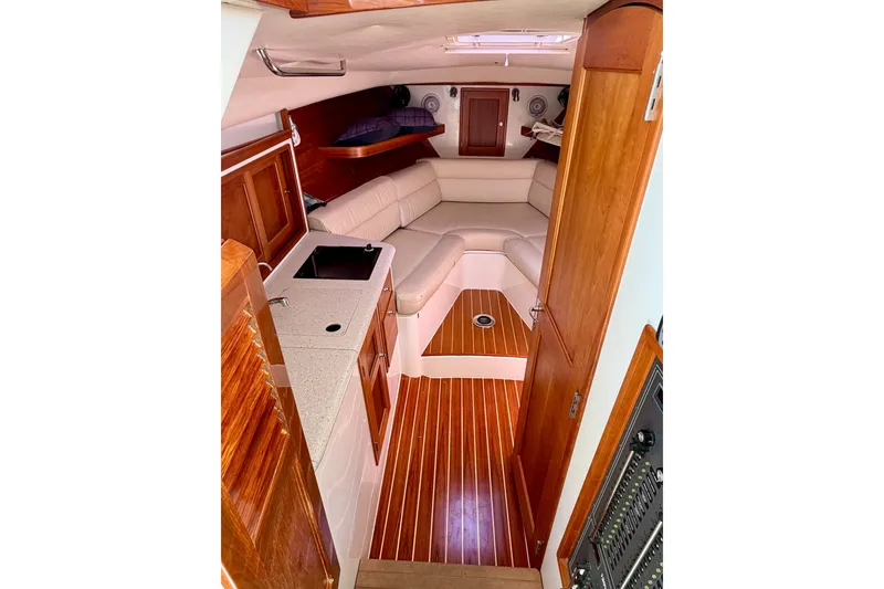 Slide: The Image of Interior of 2009 MJM 29z Downeast boat with wood finish and cozy seating area. - 15