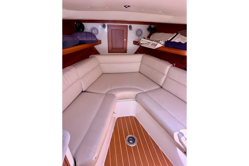Slide: The Image of 2009 MJM 29z Downeast boat interior with beige seating and wooden flooring. - 18