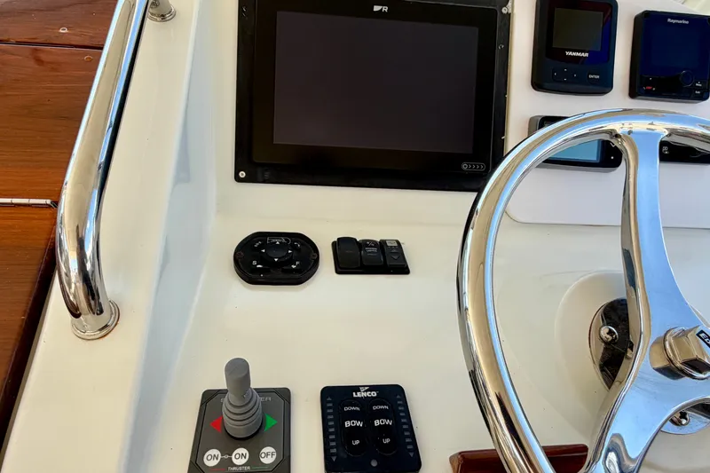 Slide: The Image of Control panel of a 2009 MJM 29z Downeast boat with steering wheel and navigation instruments. - 14