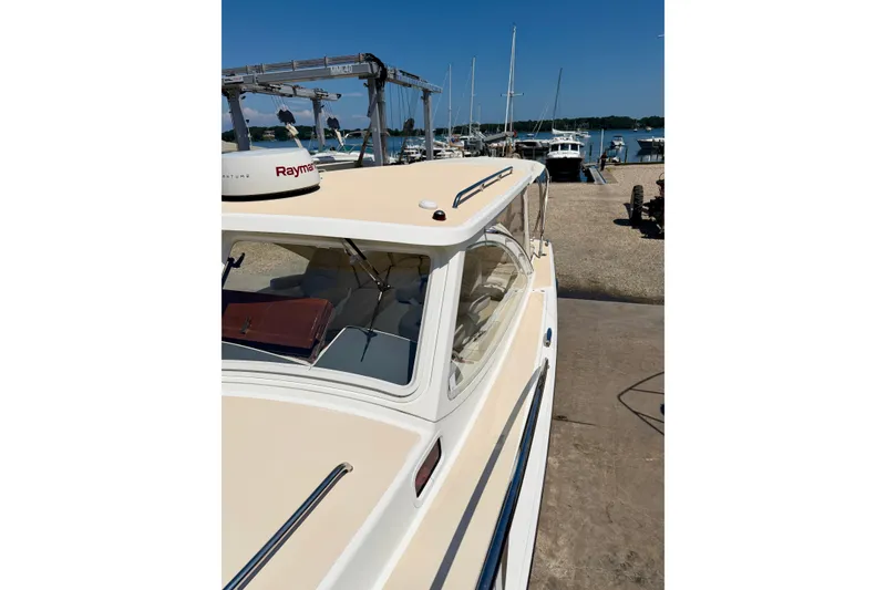 Slide: The Image of 2009 MJM 29z Downeast boat docked at marina with clear blue sky. - 28