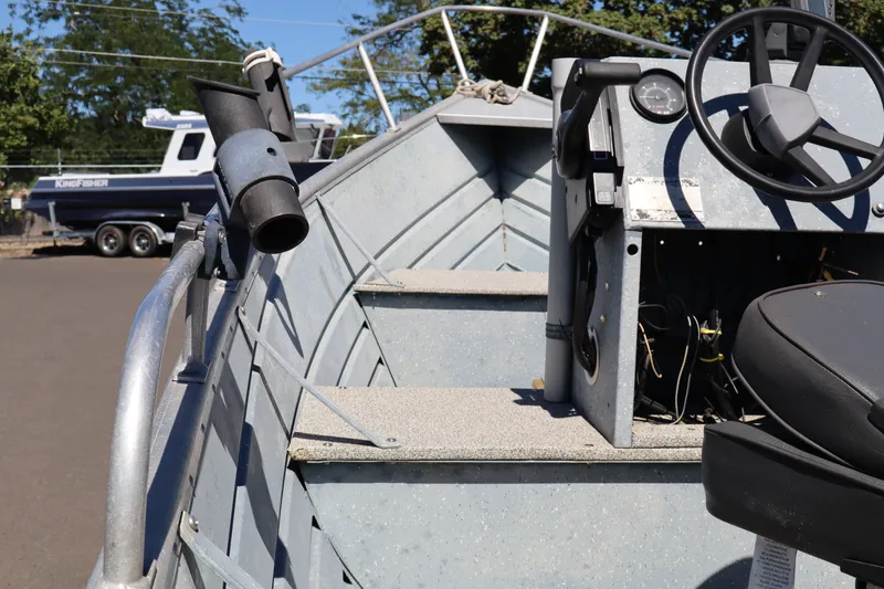 Slide: The Image of 1985 Klamath 15 boat interior with steering wheel and control panel. - 10