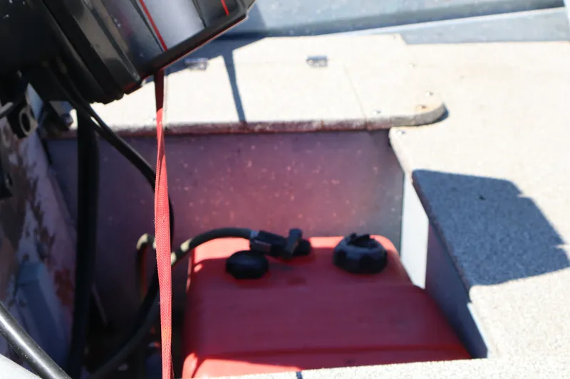 Slide: The Image of 1985 Klamath 15 boat interior with red fuel tank and engine components. - 9