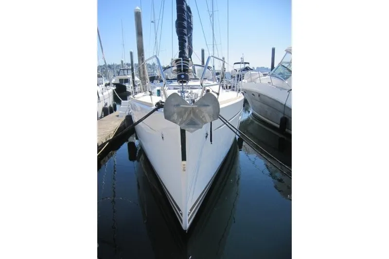 Slide: The Image of 2013 Jeanneau Sun Odyssey 469 sailboat docked in a marina, front view. - 45