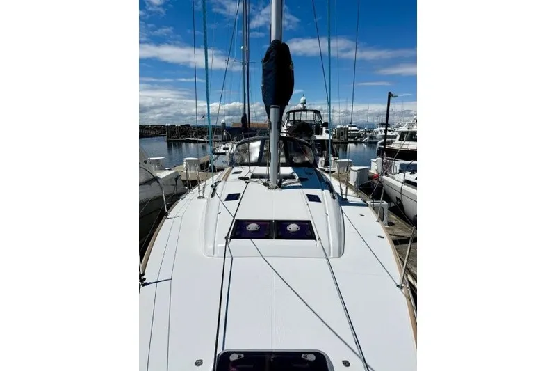 Slide: The Image of 2013 Jeanneau Sun Odyssey 469 sailboat docked at marina under blue sky. - 56