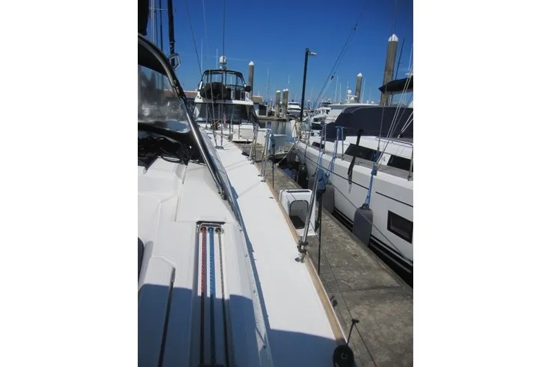 Slide: The Image of 2013 Jeanneau Sun Odyssey 469 sailboat docked at marina, clear blue sky. - 40